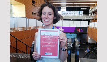 Luiza Avezum wins the price for the best oral presentation award at the ICEF14 2023 conference